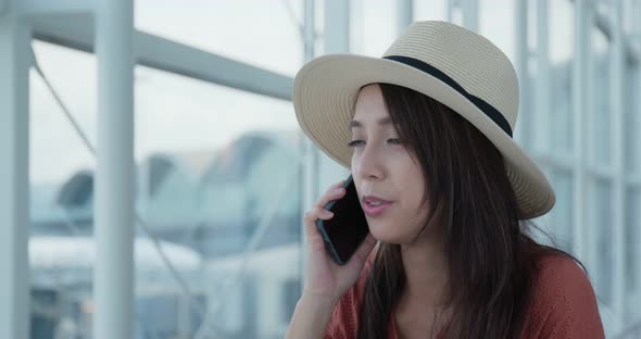 Woman talk to cellphone in the airport