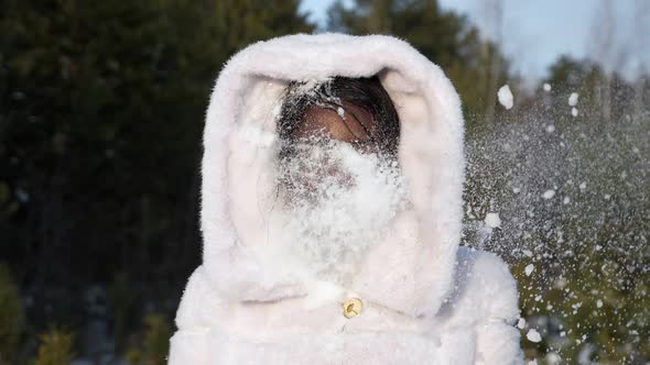 Happy Black Girl in Fur Hood Gets Snowball in Face Smiling