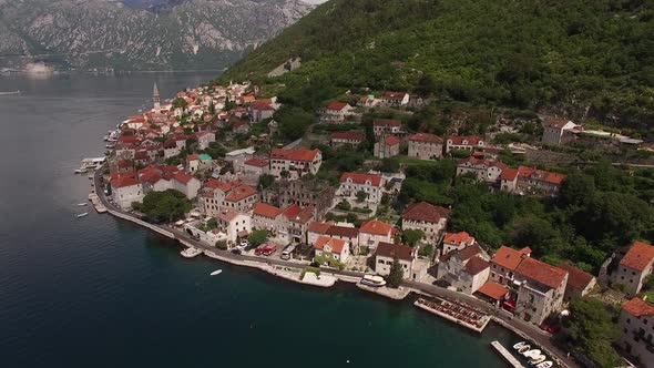 Aerial View of the Red Roofs of Perast Houses at the Foot of the Mountains