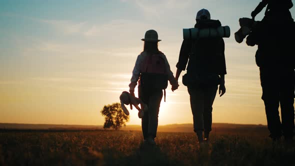 Silhouettes of Father Mother and Children Hiking