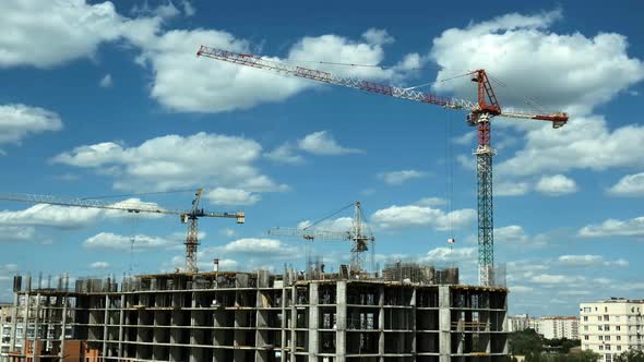 Time lapse builders and cranes working on the construction site 