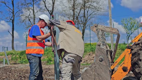 Installing metallic carcass. Engineers setting steel frames for solar power station