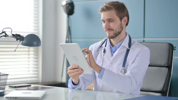 Doctor Using Smartphone While Sitting in Clinic