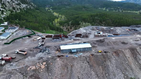 Heavy machinery drills tunnel through the mountain aerial view 4 K