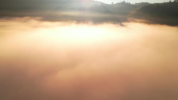 4K Aerial view flying in fog. clouds at sunset fog.
