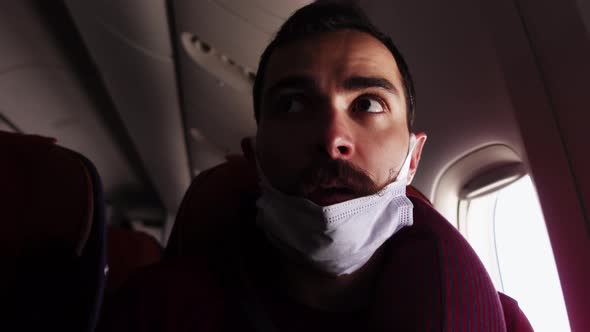 Passenger Sits Inside of Plane with Mask Pulled on the Chin When Somebody Asks Him to Wear It