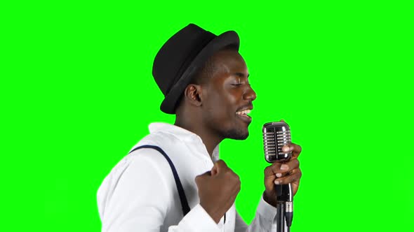 Male African American Musician in Half of the Turnover Singing in a Recording Studio. Green Screen