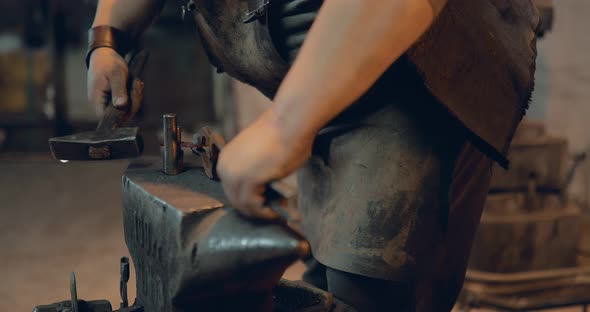 Blacksmith Hammers on the Horseshoe