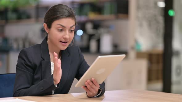 Excited Young Indian Businesswoman Celebrating Success on Tablet