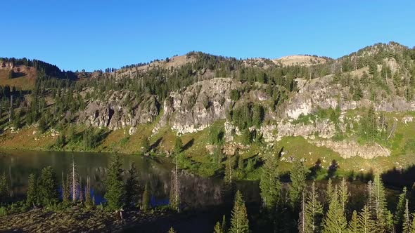 Slow turning zoom of a picturesquelake with the mountains reflecting off the water