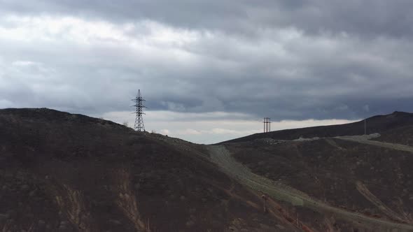 Aerial View of the Mountain Against the Background of Clouds and a Mountain Range