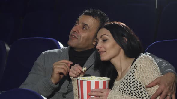 Mature Happy Couple Enjoying Their Date at the Cinema Watching a Movie