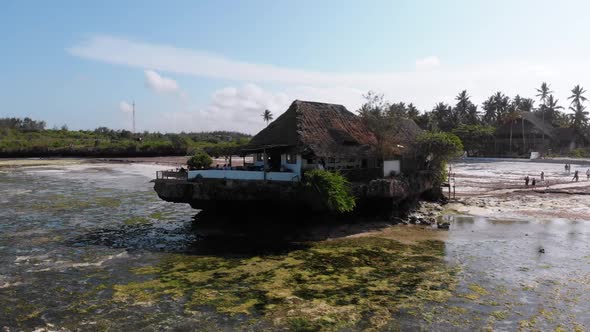 The Rock Restaurant in Ocean Built on Cliff at Low Tide on Zanzibar Aerial View