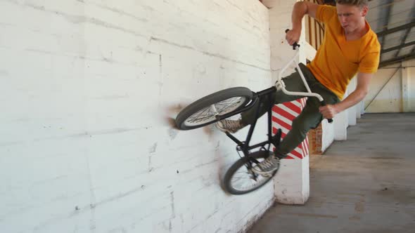 BMX rider in an empty warehouse