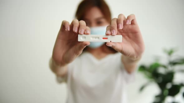 Woman showing test results of Rapid Antigen test COVID-19