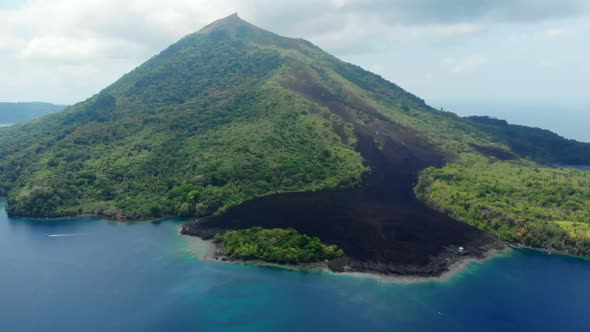 Aerial: flying over Banda Islands active volcano Gunung Api lava flows Indonesia