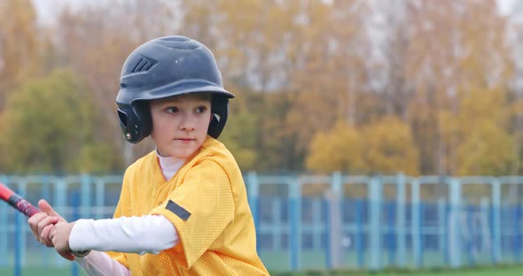 Portrait of a Boy Baseball Player on a Blurry Background the Batter in Protective Gear Waiting for a