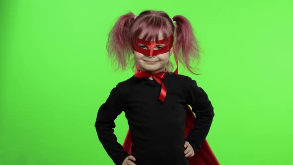 Funny Child Girl in Costume and Mask Plays Super Hero. National Superhero Day