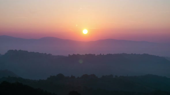 Sunrise Time Lapse Over Hills and Mountains