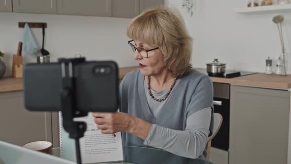 Senior Tutor Giving Online Lesson at Home