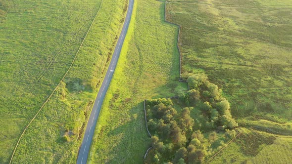 Aerial view of an empty road in English countryside at sunset