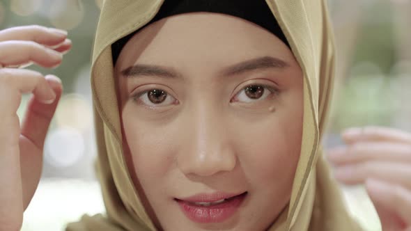 Close-up, beautiful Muslim girl smiling in hijab