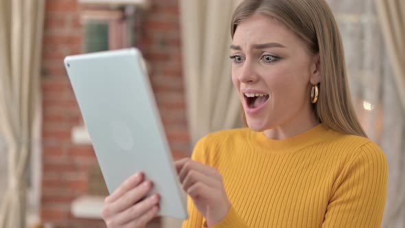 Portrait of Cheerful Young Woman Celebrating Success on Tablet