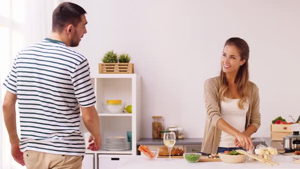 Happy Couple Cooking Food at Home Kitchen