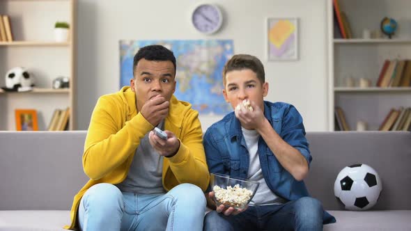 Anxious Teenage Friends Watching Football Match on TV and Eating Popcorn Leisure