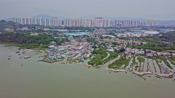 A dynamic descending aerial footage of the fishing village in Lau Fau Shan in the New Territories of