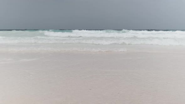 Landscape of Beautiful Tropical Beach with Tidal Waves and Blue Sky Zanzibar