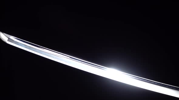 Dramatic Studio Shot of Man Holding Samurai Sword. Close Up