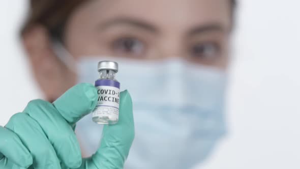 Doctor holding vial of Covid-19 vaccine