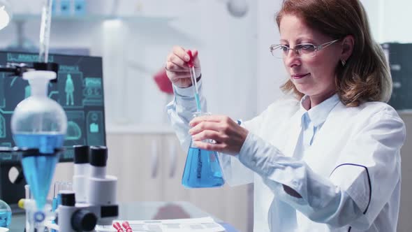 Female Researcher Takes Samples From a Tube