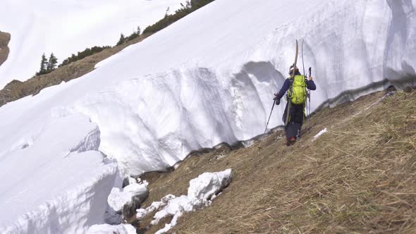 Men Skier is Hiking in Big Avalanche Gap in Sunny Winter Season in Alpine Mountains