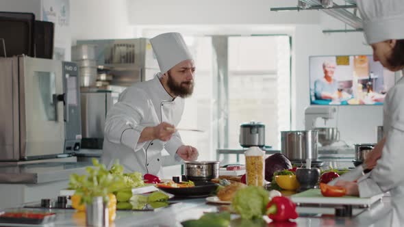 Professional Chef Testing Soup Taste in Pot on Stove