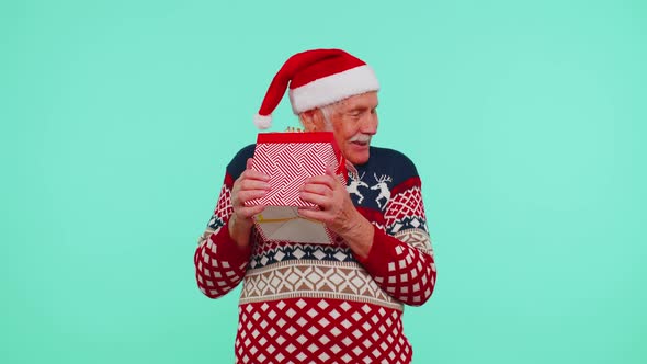 Grandfather Man in Sweater Santa Christmas Getting Present Gift Box Expressing Amazement Happiness