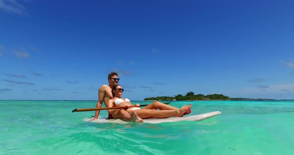 Young boy and girl after marriage in love have fun on beach on summer white sandy background