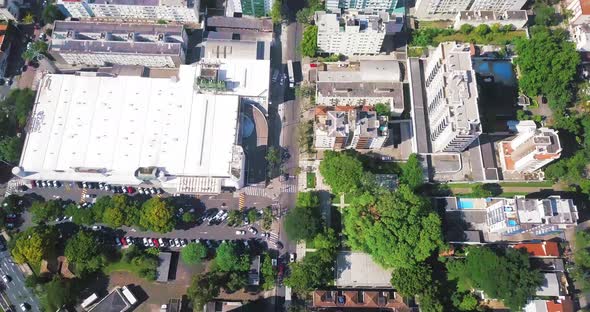 Drone showing Top View of City Avenue with Traffic and then Moves to City Skyline