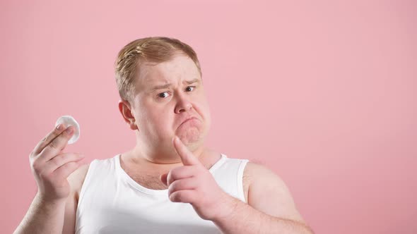 Funny Glad Jouful Man in Undershirt Applying Tonic By Cotton Pad on Face