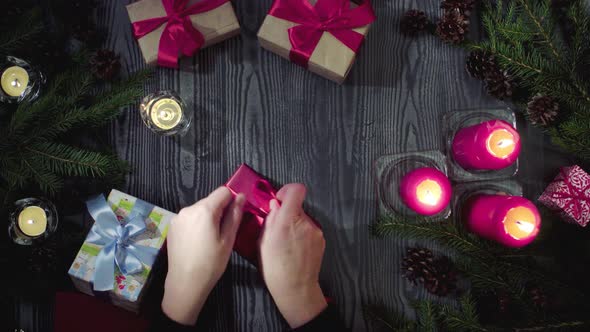 Female Hands Tying New Year Gifts