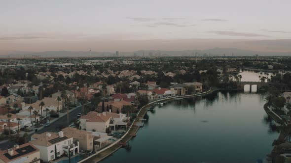 Aerial drone flight over Las Vegas suburb on lake