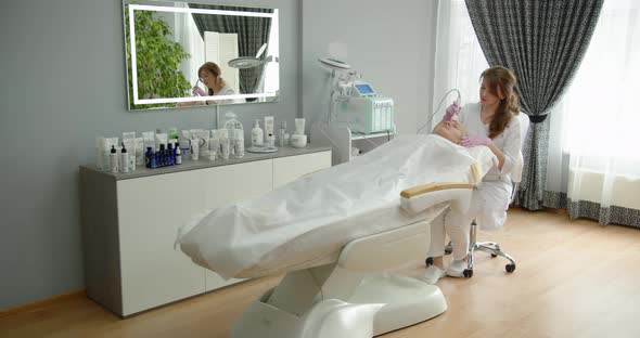 Attractive Woman In A Cosmetology Clinic Receives A Phonophoresis Procedure For The Skin