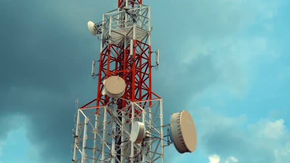 Large Telecommunication Tower Against Sky and Clouds in Background