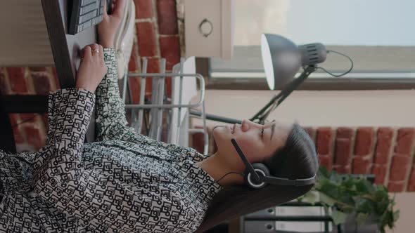 Vertical Video Worker at Customer Service Using Microphone on Phone Call