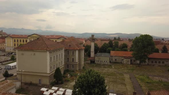 Aerial Establishing shot of Eastern European Town (Romania) green patches of grass in the foreground