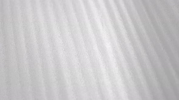 White striped thin protective foam plastic for package. Abstract background. Macro