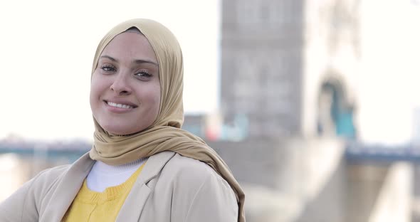 Smiling woman wearing hijab in the city, London, England