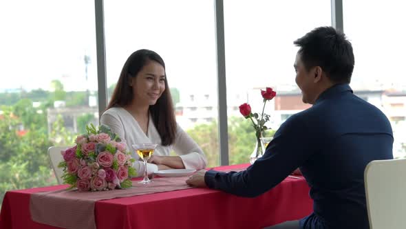 Happy Romantic Couple Eating Lunch at Restaurant