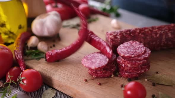 Sausage Slices on the Wooden Cutting Board at Domestic Kitchen